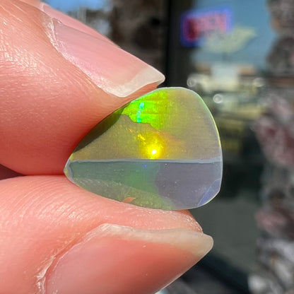 A loose, pear shaped black opal stone from Lightning Ridge, Austalia that weighs 1.19 carats.