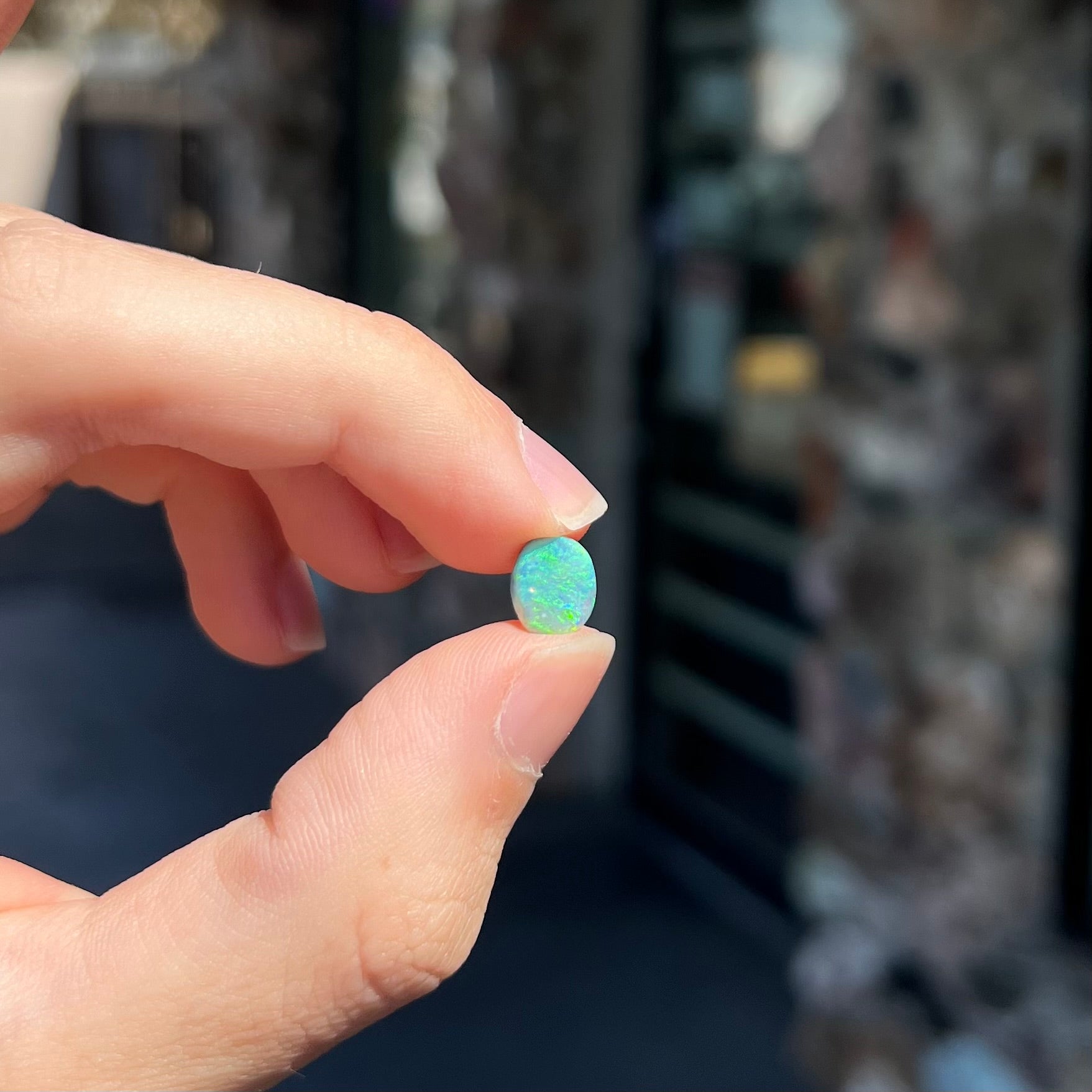 A loose, 1.26 carat semi-black opal stone from Lightning Ridge, Australia.  The opal is green and blue.