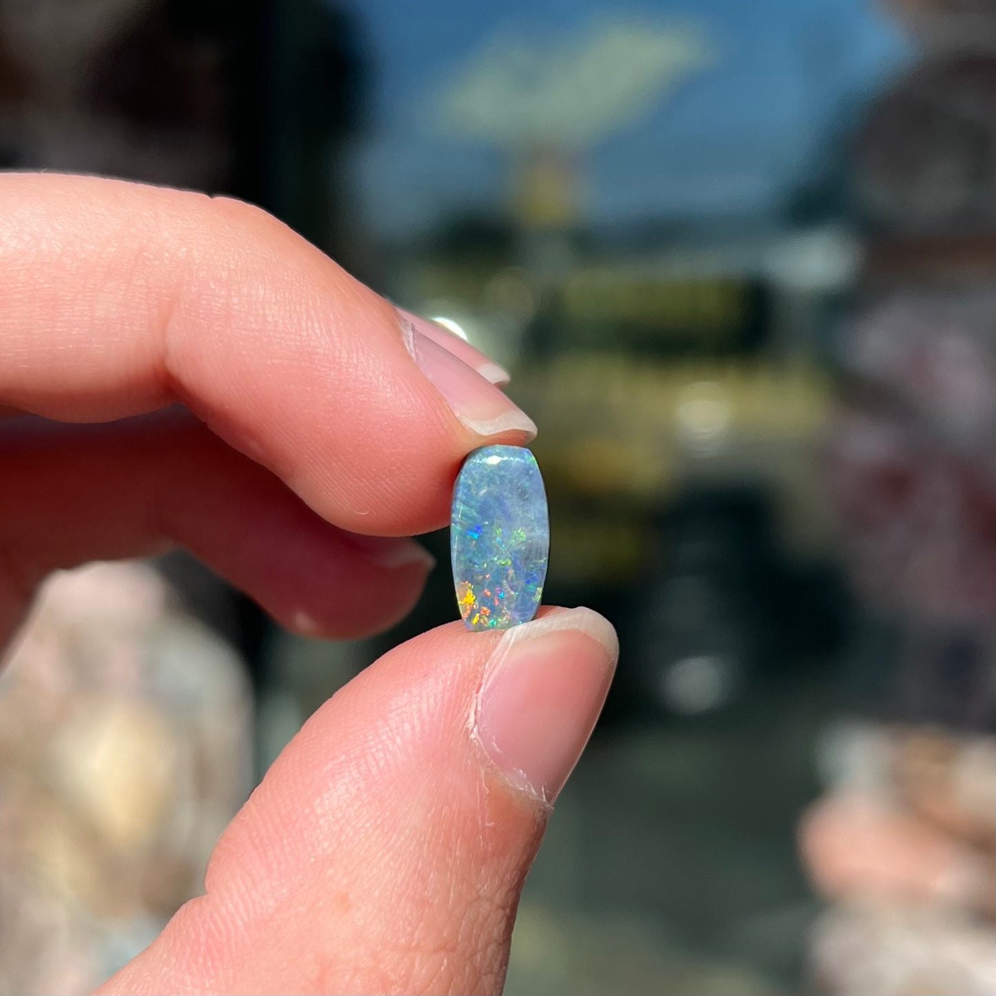 A loose 1.76ct barrel shaped black opal stone from Lightning Ridge, Australia.  The opal has a rainbow of colors.