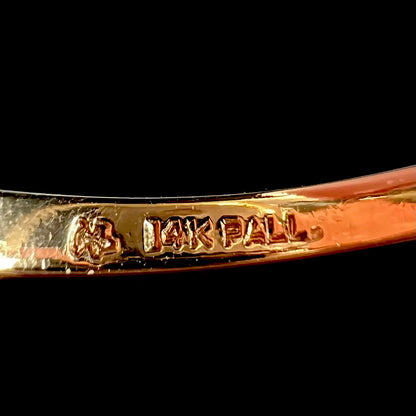 A ring's shank stamped "14K PALL".