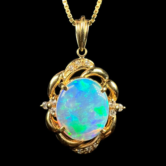 An 18 karat yellow gold diamond-accented necklace mounted with a green and blue Lightning Ridge crystal opal.