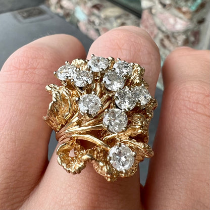 A ladies' 1950's style yellow gold and diamond cluster ring.  The ring is shaped like a leaf with 10 round diamonds set in it.