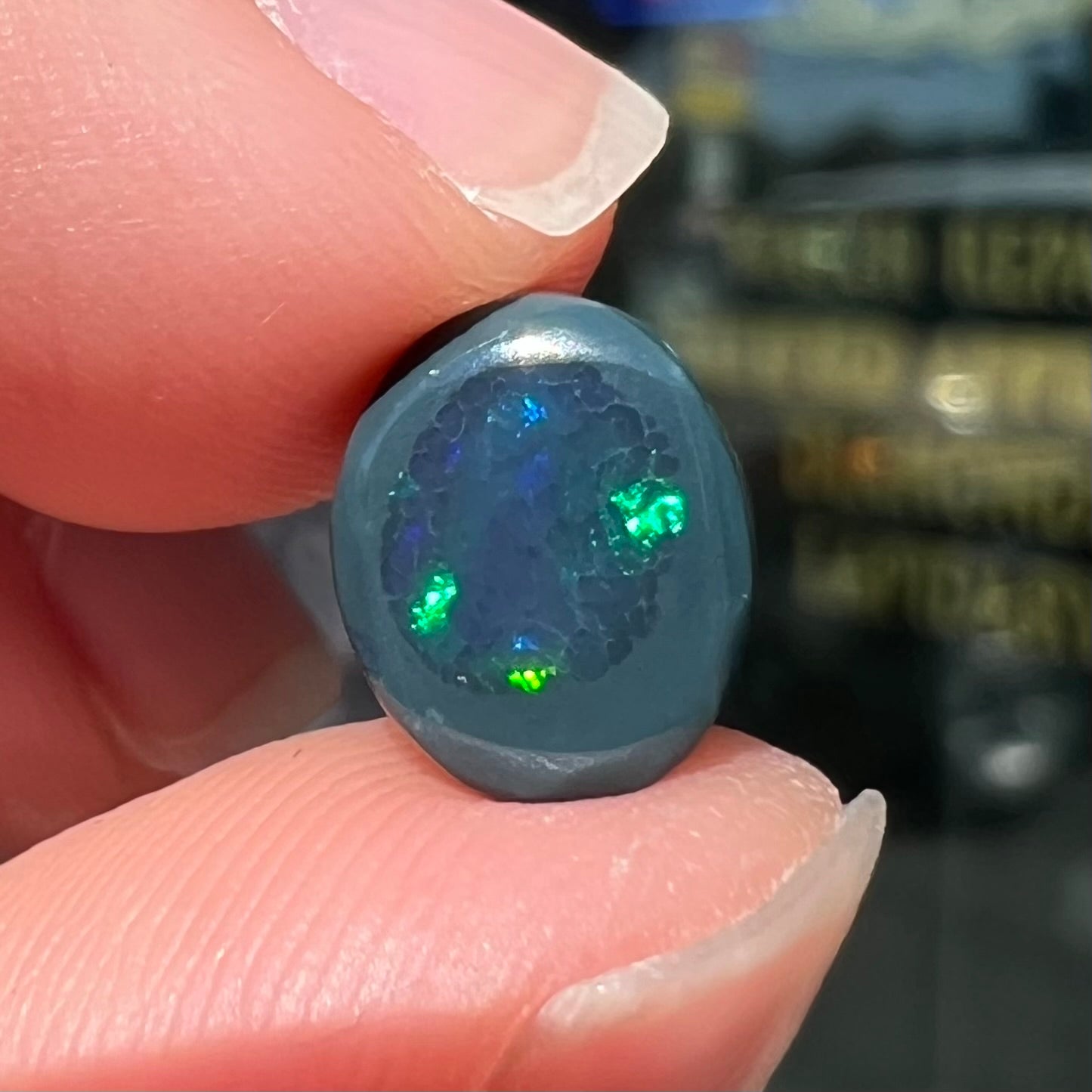 A 2.68 carat loose, oval cabochon cut black opal stone from Lightning Ridge, Australia.  The opal has a N2 body tone.