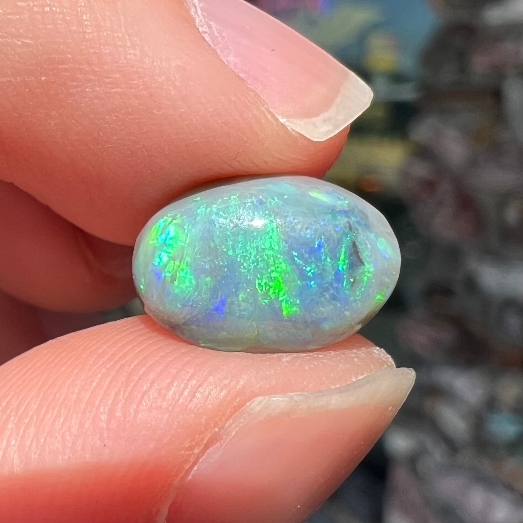 An oval cabochon cut 2.75ct semi-black opal gemstone from Lightning Ridge, Australia.