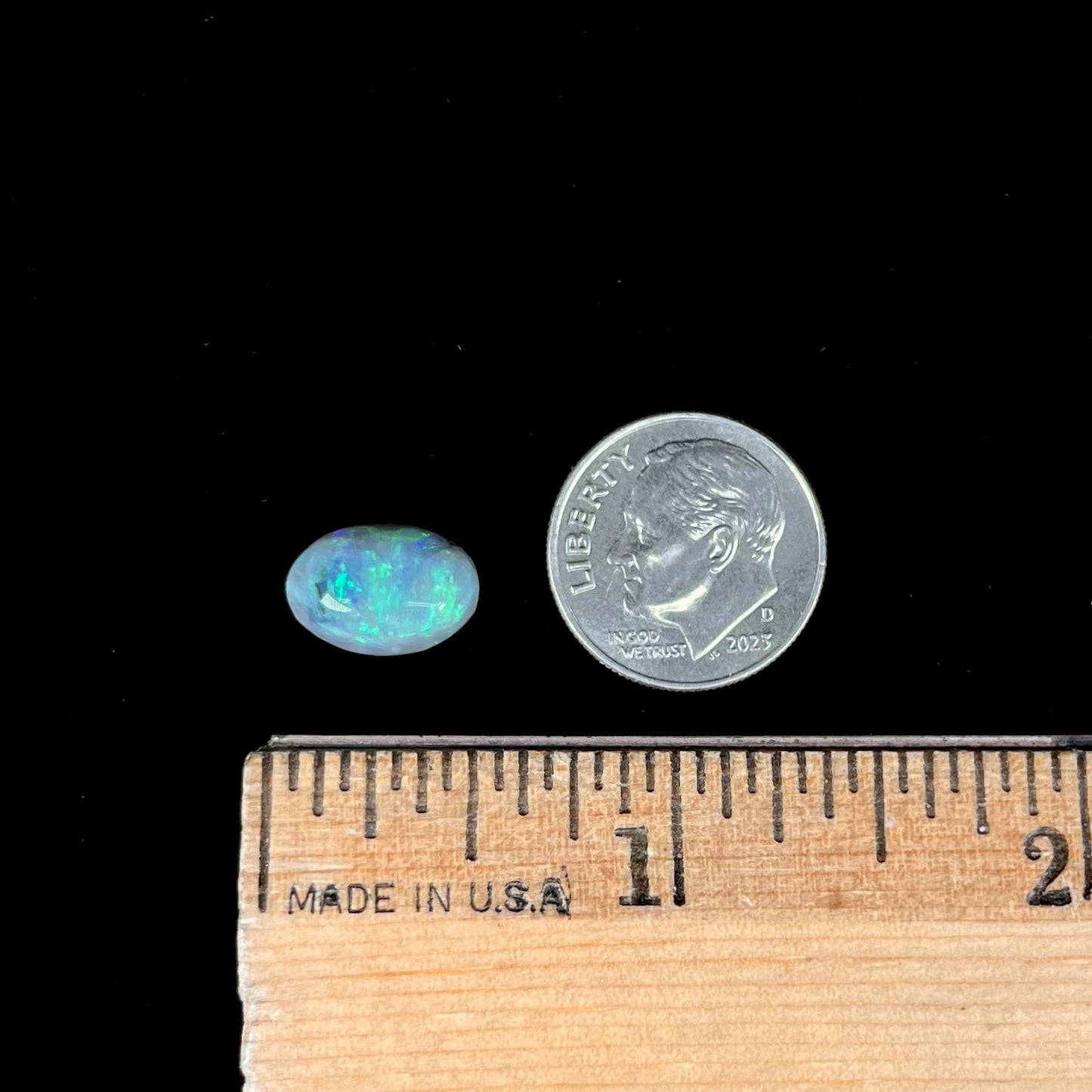 An oval cabochon cut 2.75ct semi-black opal gemstone from Lightning Ridge, Australia.