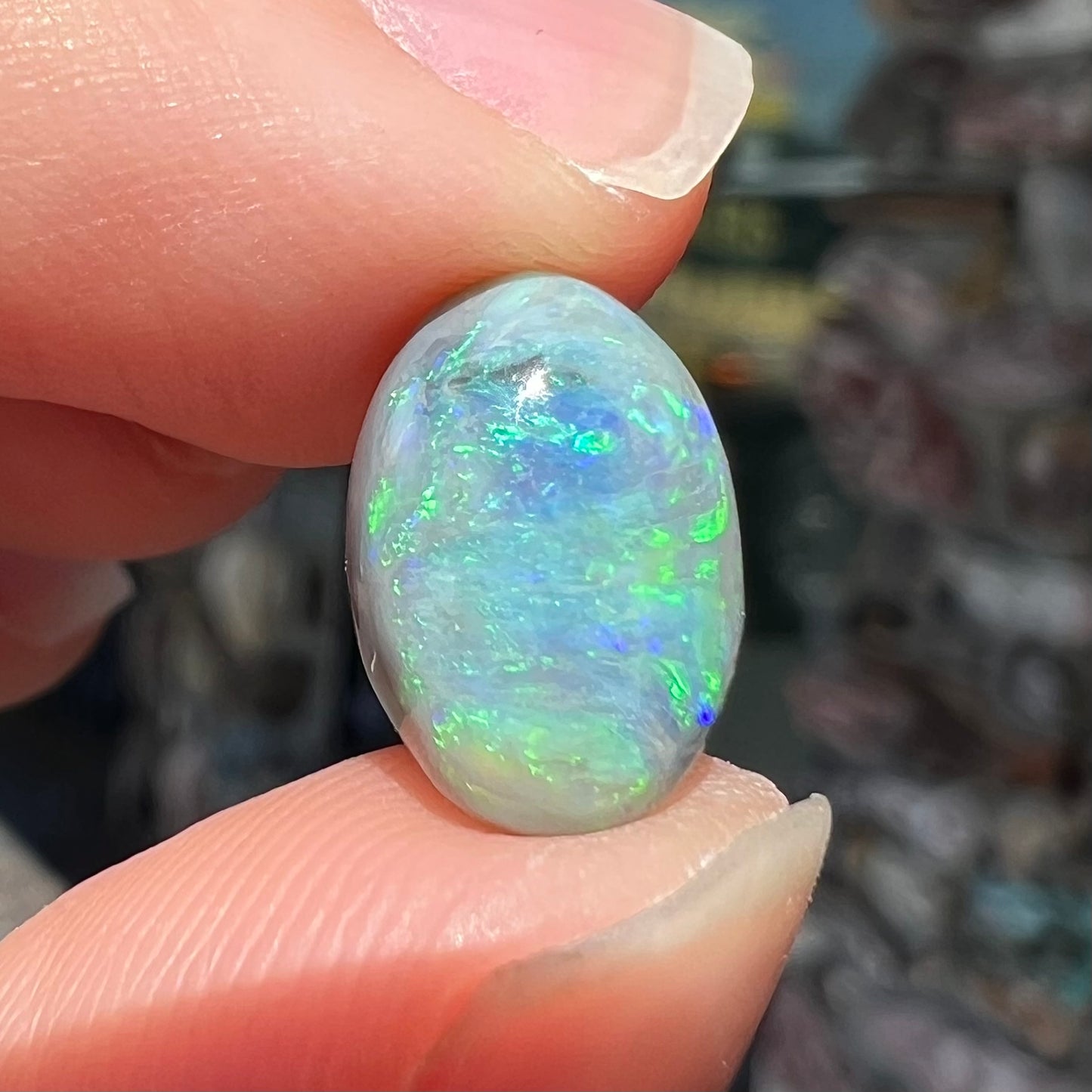 An oval cabochon cut 2.75ct semi-black opal gemstone from Lightning Ridge, Australia.