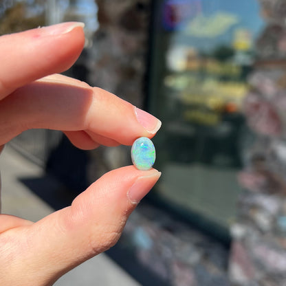 An oval cabochon cut 2.75ct semi-black opal gemstone from Lightning Ridge, Australia.