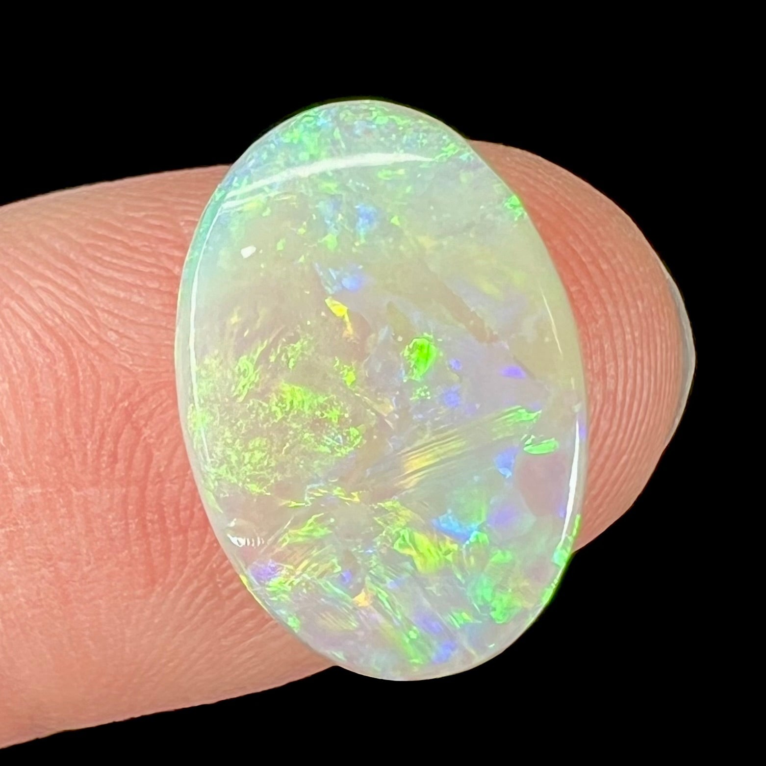 A double-sided opal stone from Coober Pedy, Australia.  The opal plays green, blue, and orange colors from the front and the back.