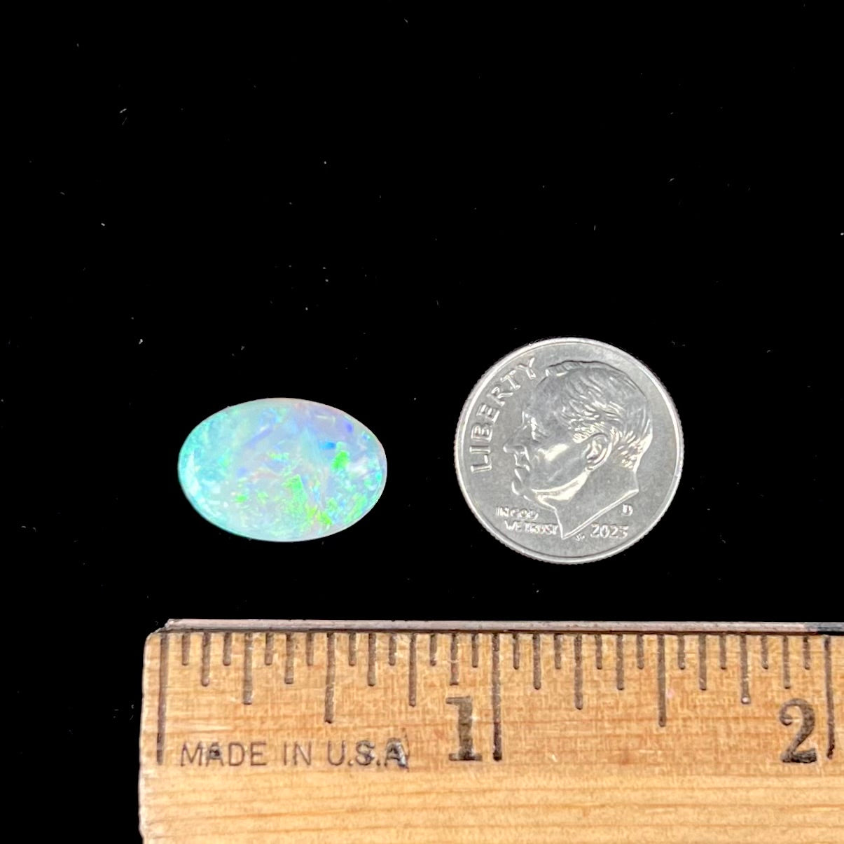 A double-sided opal stone from Coober Pedy, Australia.  The opal plays green, blue, and orange colors from the front and the back.