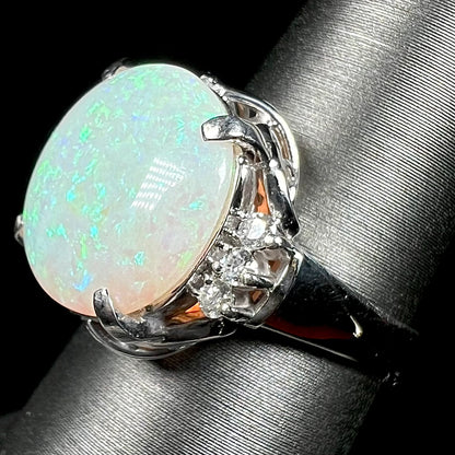 A round cut Australian opal and diamond engagment ring with platinum filigree.