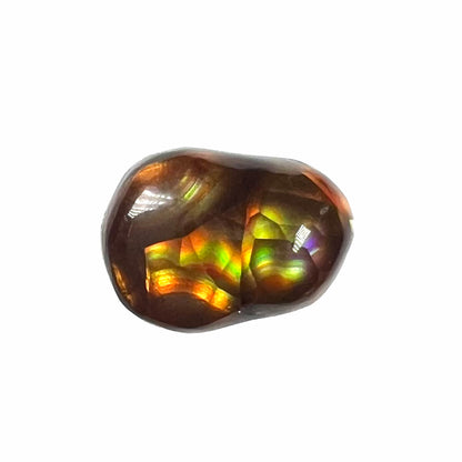 A loose, freefrom cabochon cut Mexican fire agate stone.  The stone has red, green, yellow, and purple banding.