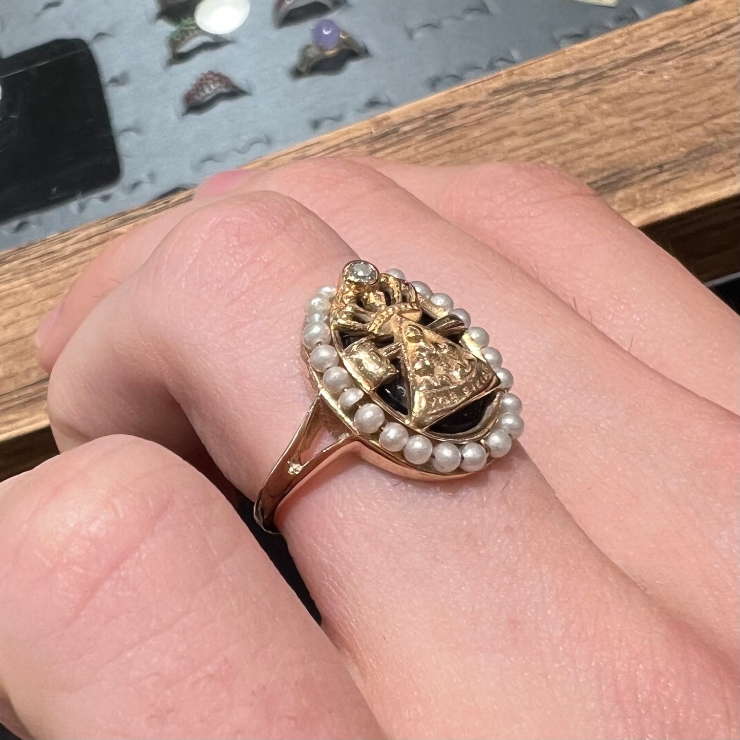 A ladies' Job's Daughters youth organization ring cast in 14 karat gold, set with a diamond and string of pearls.