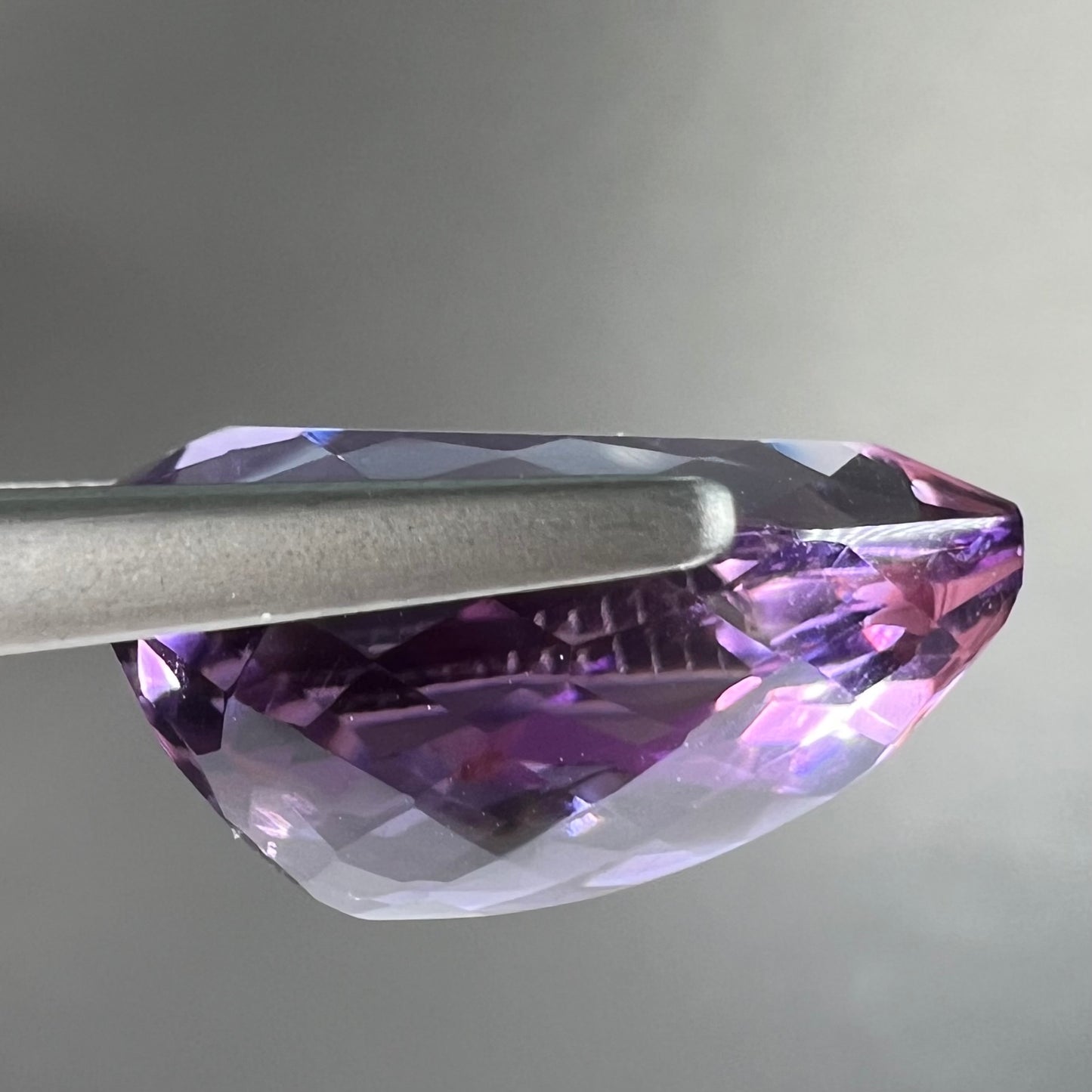 A loose, pear shaped amethyst gemstone.  The stone is a medium purple color.