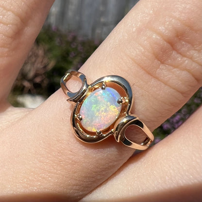 A 14 karat yellow gold open-shank design Australian crystal opal ring.