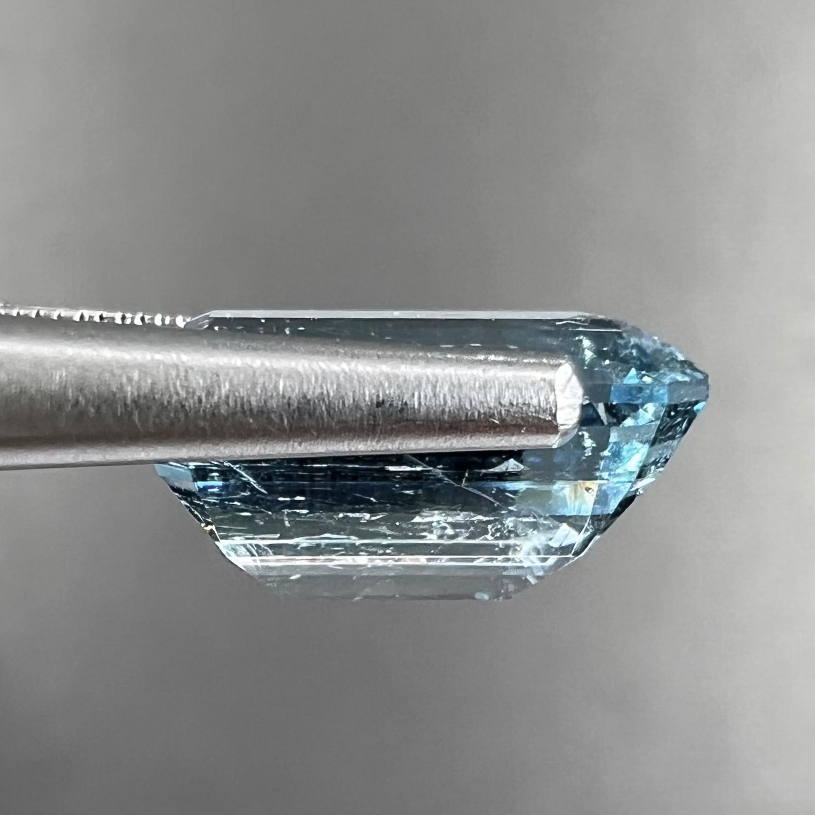 A loose, faceted emerald cut aquamarine stone.  The stone is icy blue in color, indicative of Vietnamese origin.