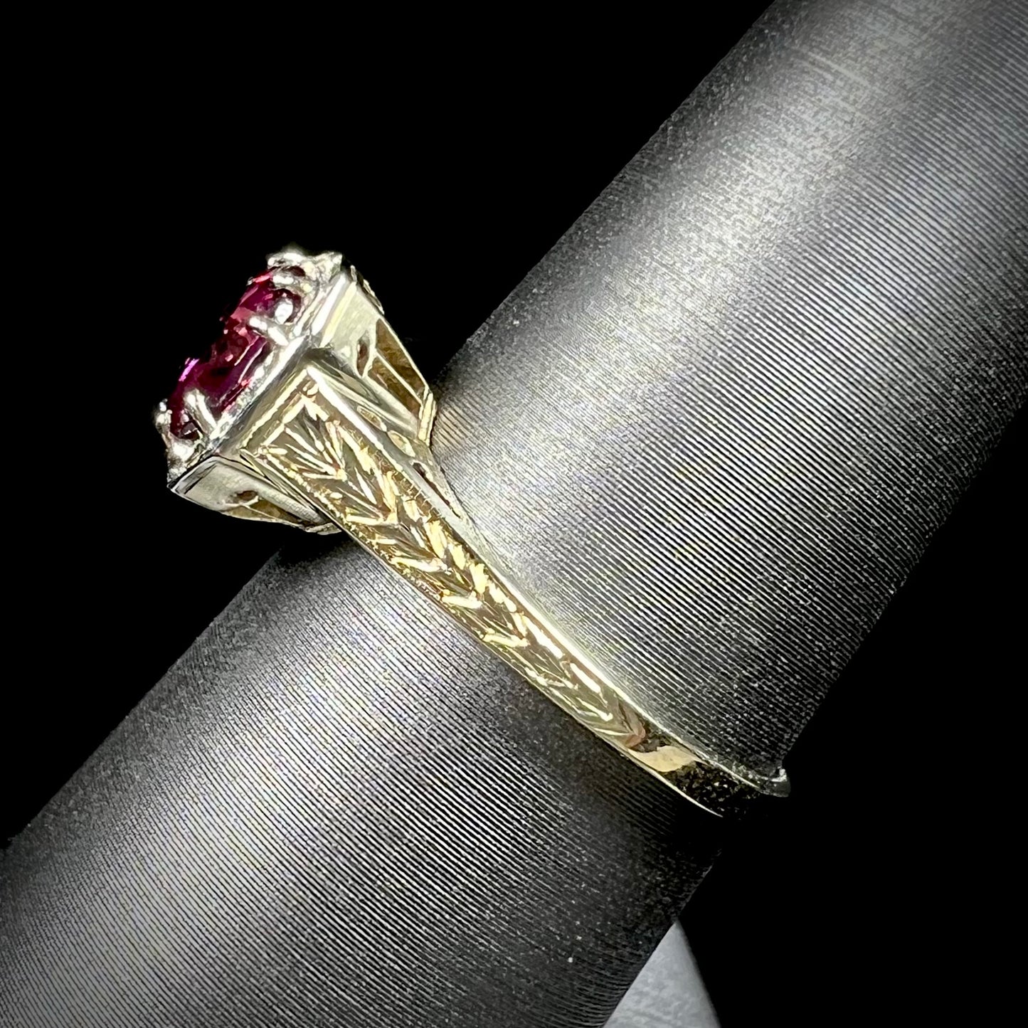 A ladies' yellow gold Art Deco style solitaire ring set with a purple rhodolite garnet gemstone.