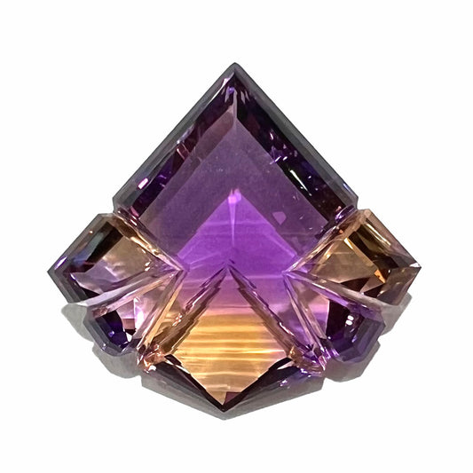 A loose, fantasy cut ametrine gemstone, carved by gem carver, Arthur Lee Anderson.