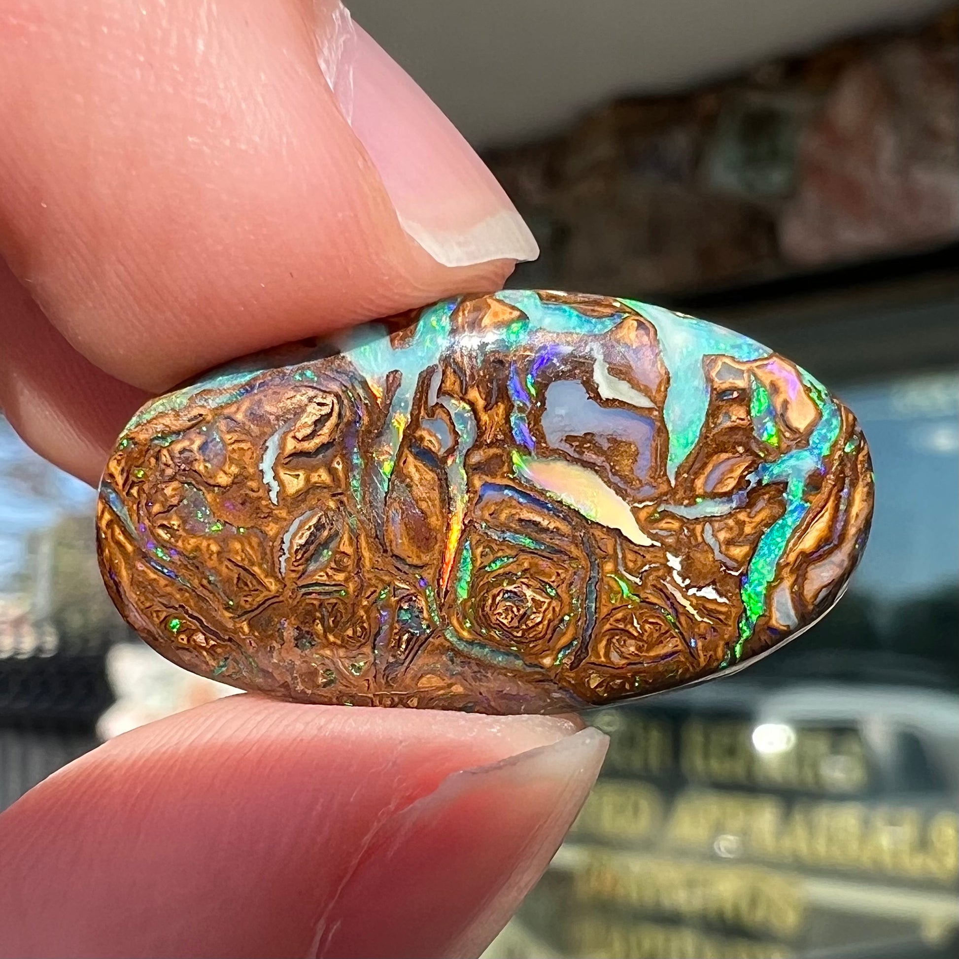 A loose, oval shaped Koroit boulder matrix opal.  The stone has patterns that resembles a rose.