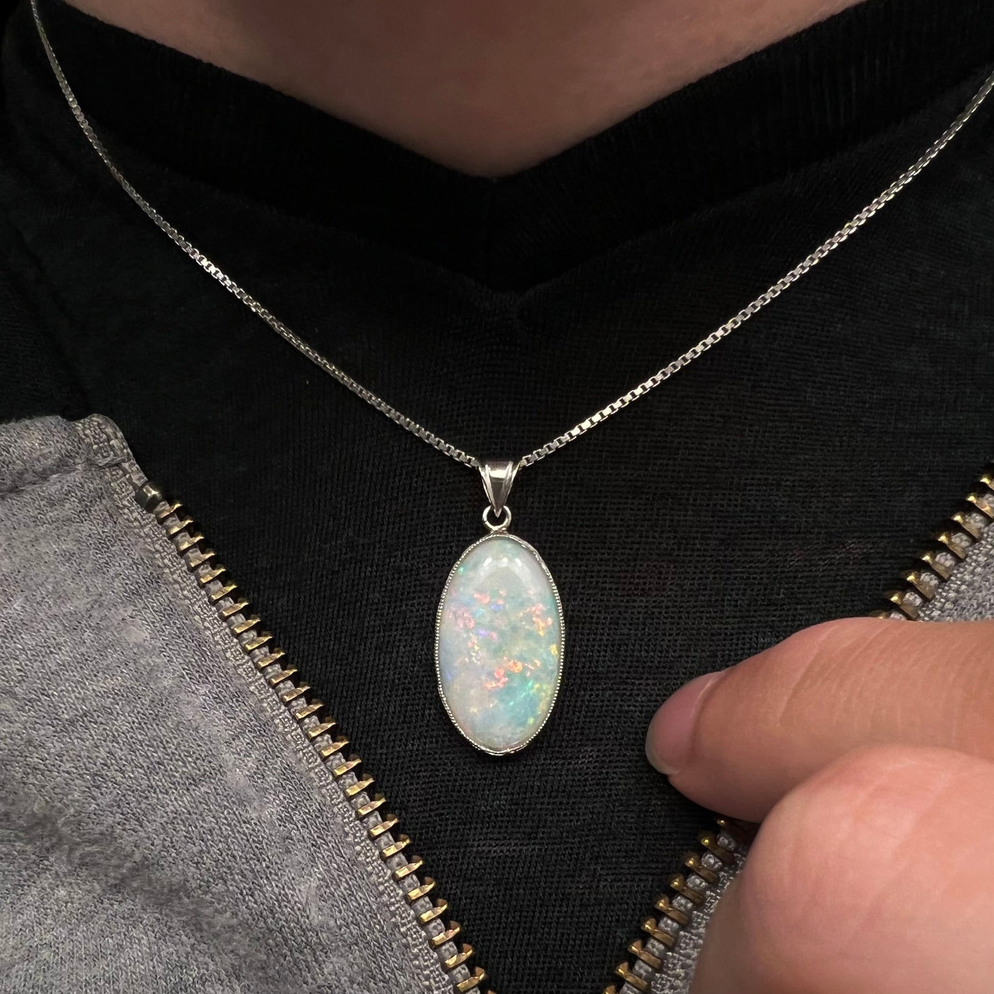 A platinum pendant mounted with an oval cut Australian white opal.