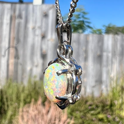 A platinum opal necklace on a platinum chain.  The opal weighs 1.49ct and has predominantly green color play.