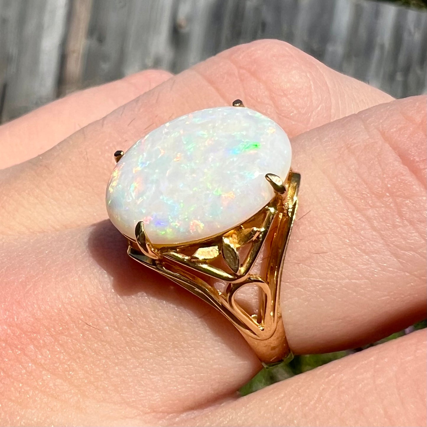 A yellow gold solitaire cocktail ring mounted with a natural white opal from Coober Pedy, Australia.