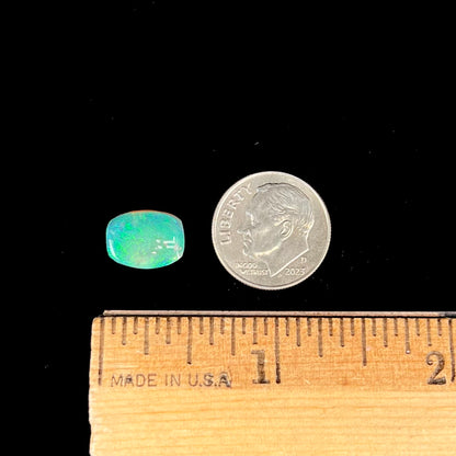 A 2.40ct barrel shaped Lightning Ridge semi-crystal opal.  The stone has blue and green colors.