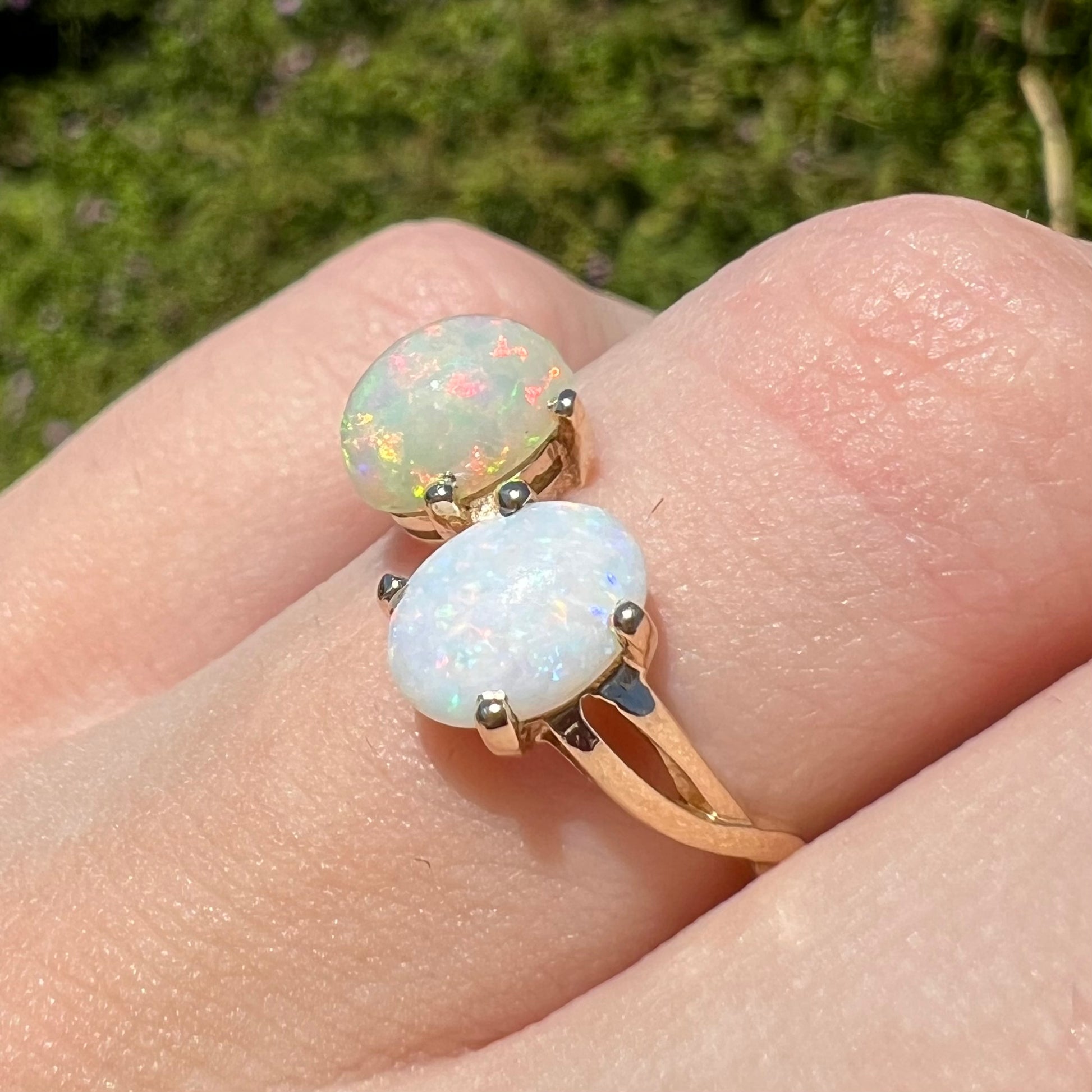 A yellow gold ring mounted with an Ethiopian fire opal and a Coober Pedy, Australian opal.