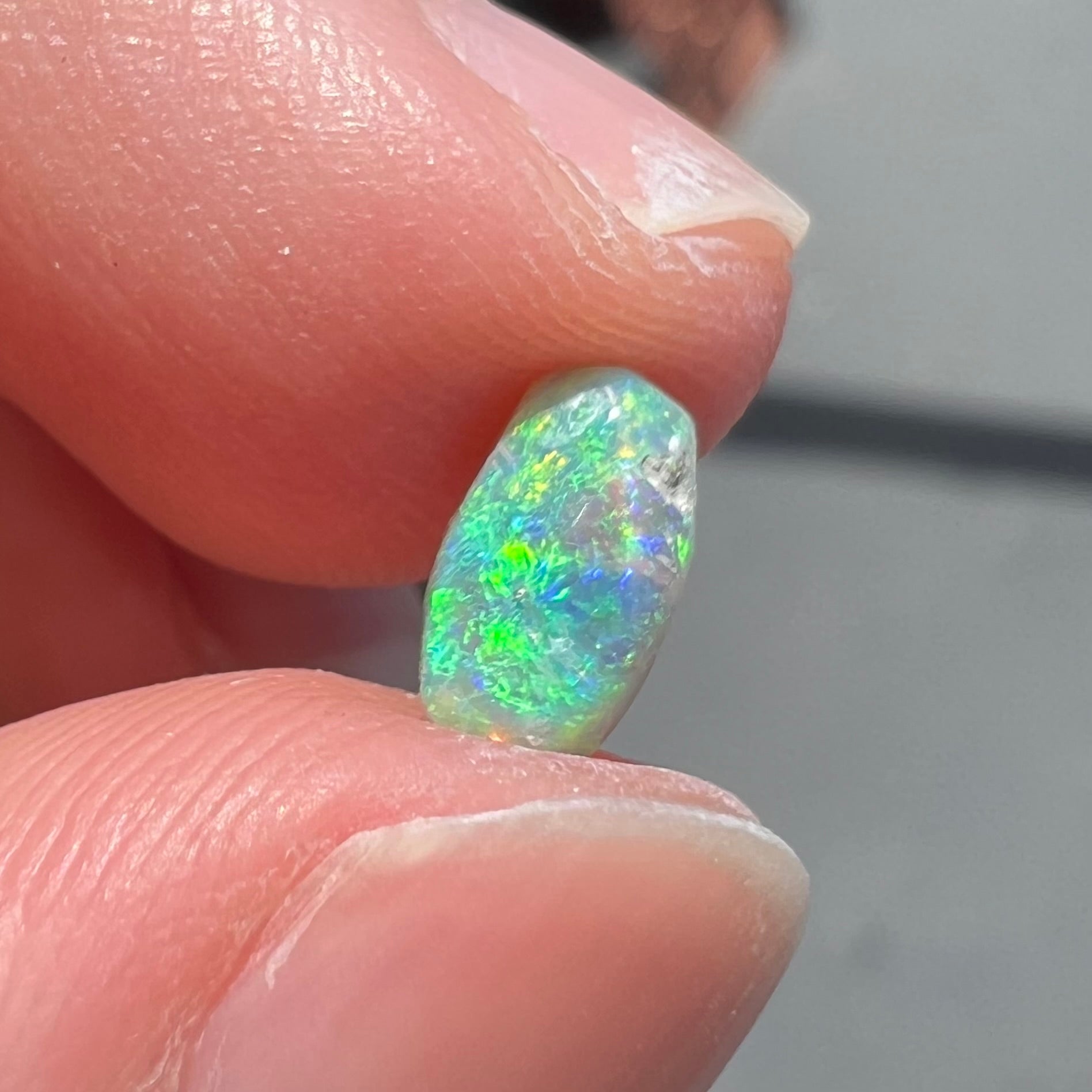 A loose, semi-crystal opal from Australia.  The opal predominantly show green and orange colors.