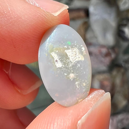 A semi-black, small flashfire opal stone from Mintabie, Australia.