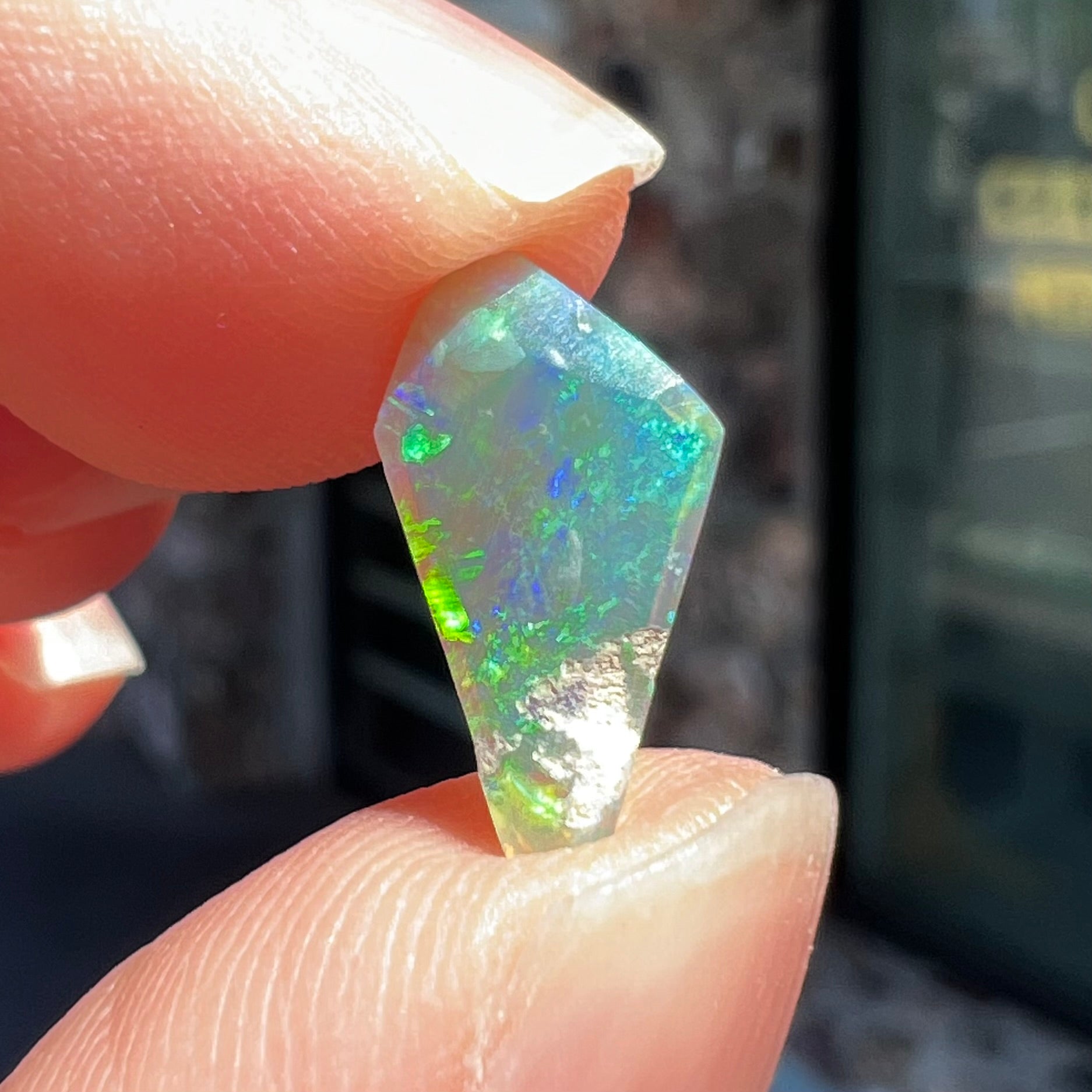 A loose, 1.27 carat Lightning Ridge crystal opal.  The opal has green colors.