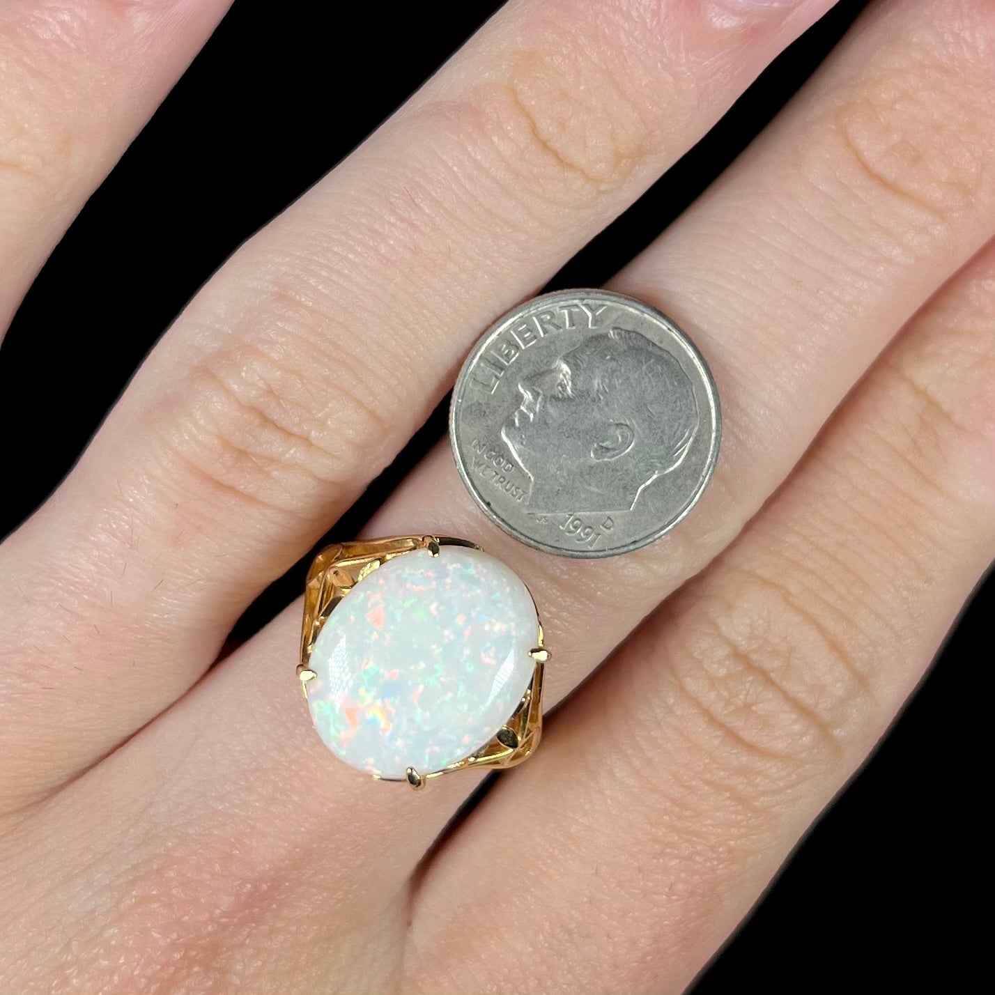 A yellow gold solitaire cocktail ring mounted with a natural white opal from Coober Pedy, Australia.