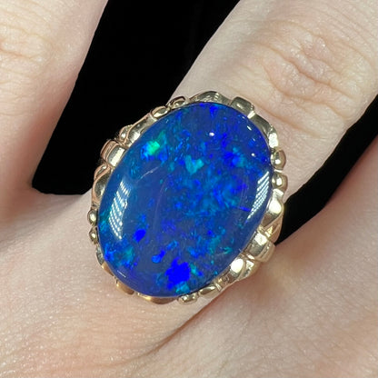 A ladies' vintage, 1940's style black opal doublet ring in yellow gold.