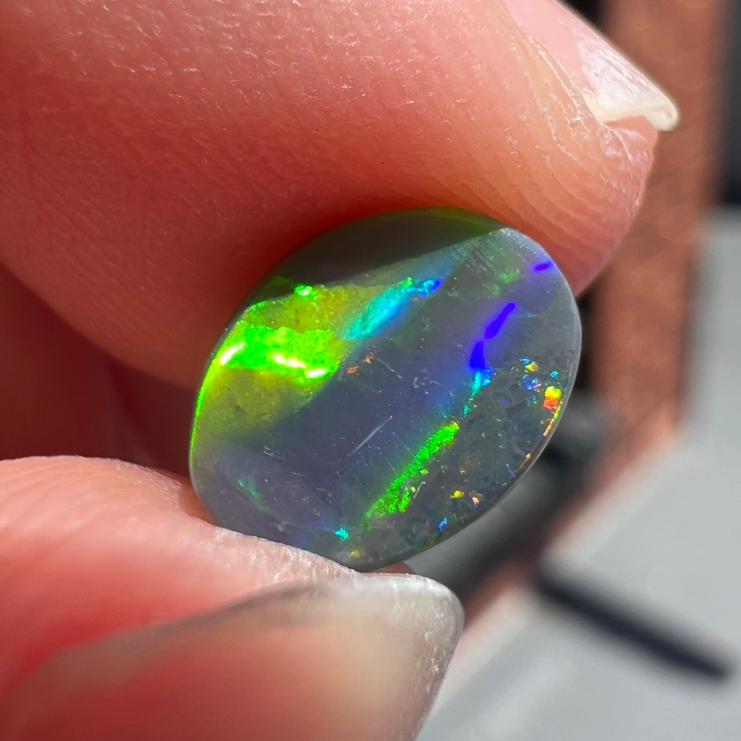 A loose, oval cut black opal from Lighting Ridge, Australia.  The stone is highly directional.