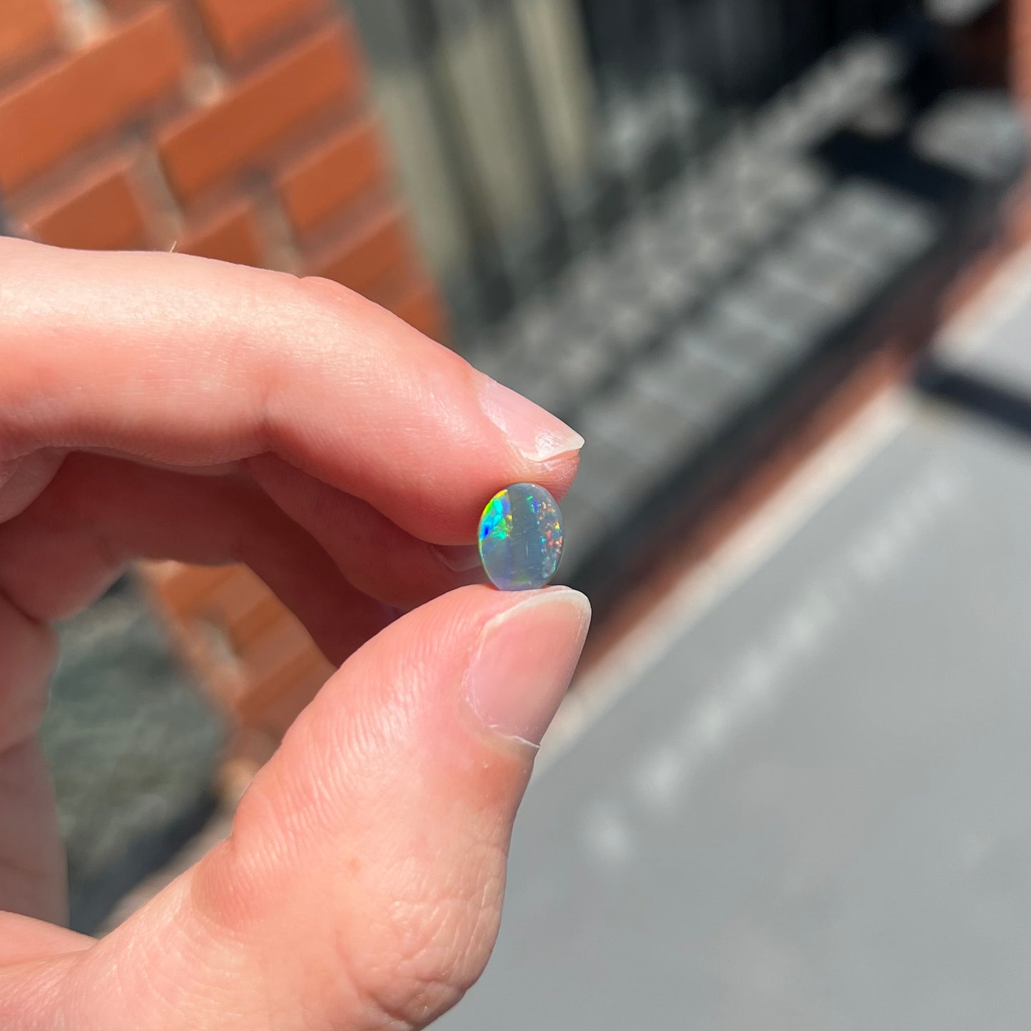 A loose, oval cut black opal from Lighting Ridge, Australia.  The stone is highly directional.