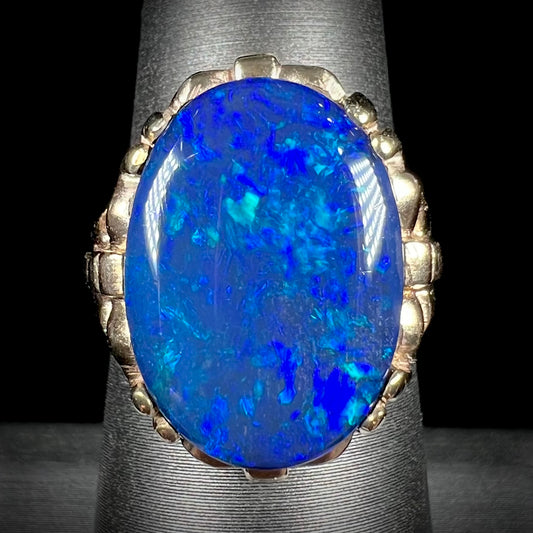 A ladies' vintage, 1940's style black opal doublet ring in yellow gold.
