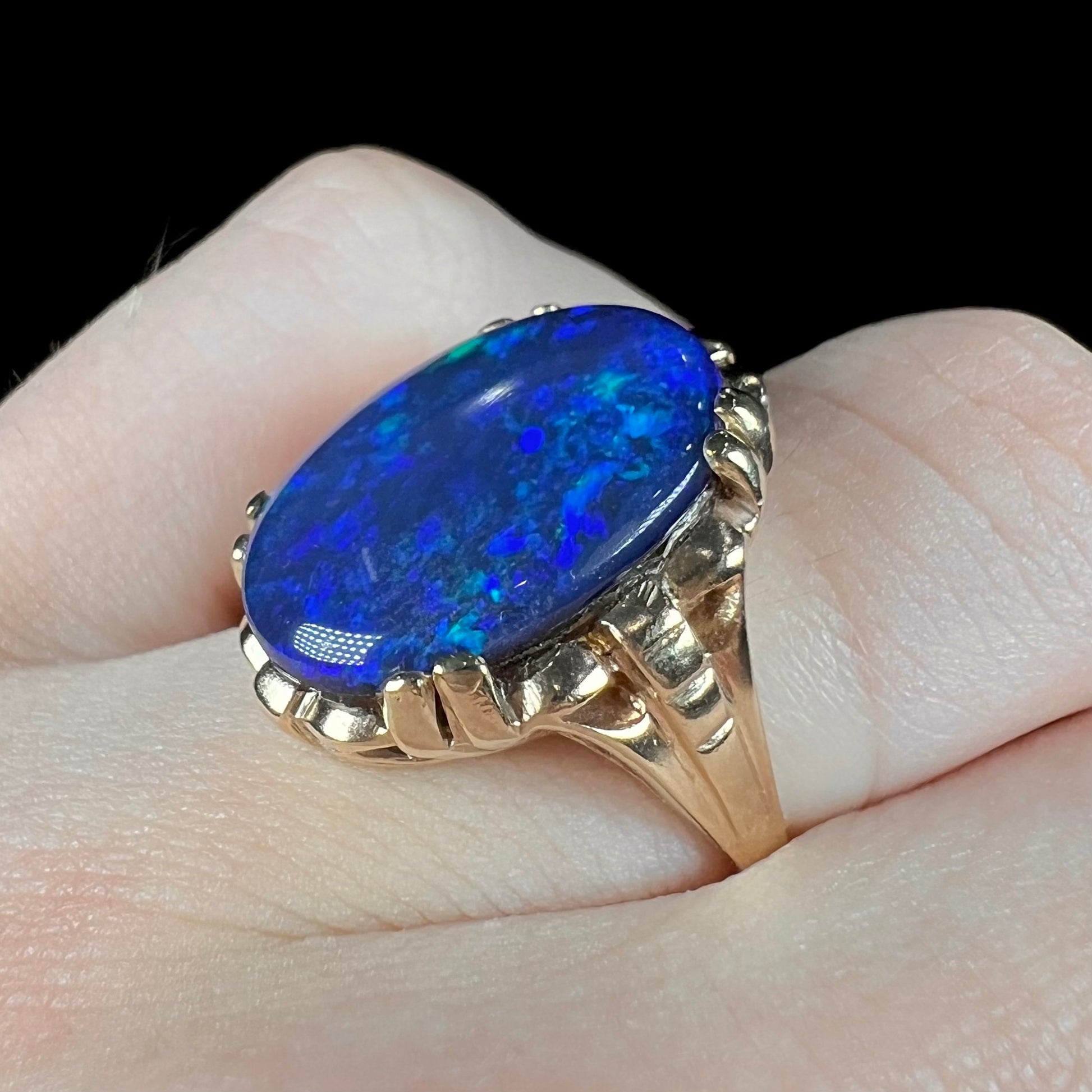 A ladies' vintage, 1940's style black opal doublet ring in yellow gold.