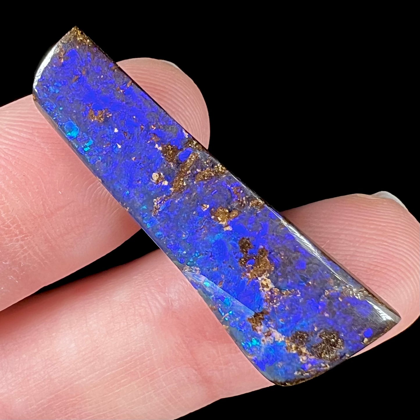 A vivid blue and purple boulder opal stone from Quilpie, Australia.