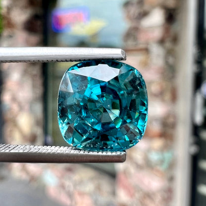 A loose cushion cut blue zircon stone.