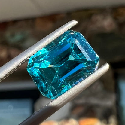 A natural blue zircon gemstone.  The stone is emerald cut.