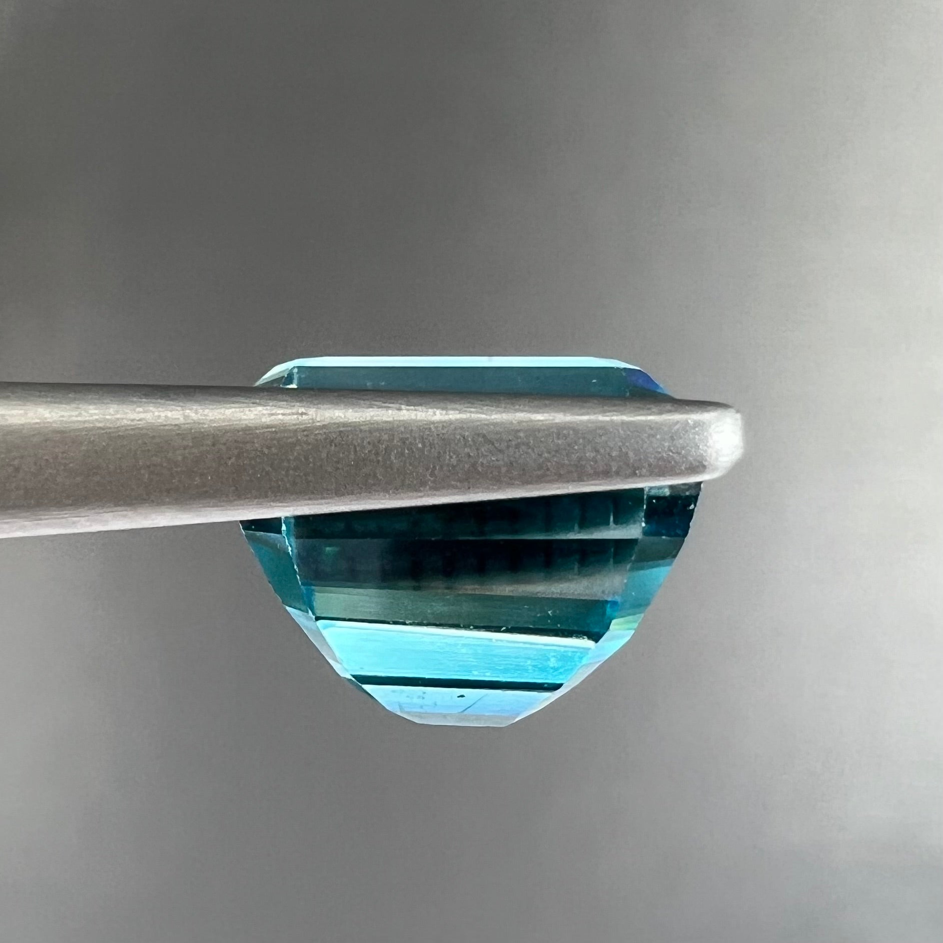 A natural blue zircon gemstone.  The stone is emerald cut.