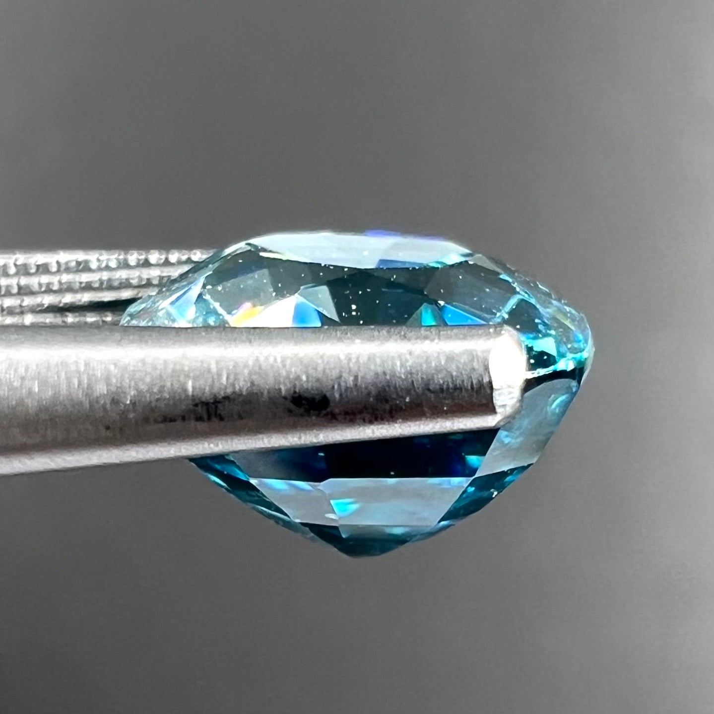 A loose cushion cut blue zircon stone.