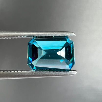 A natural blue zircon gemstone.  The stone is emerald cut.