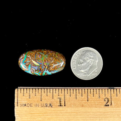 A loose, oval shaped Koroit boulder matrix opal.  The stone has patterns that resembles a rose.