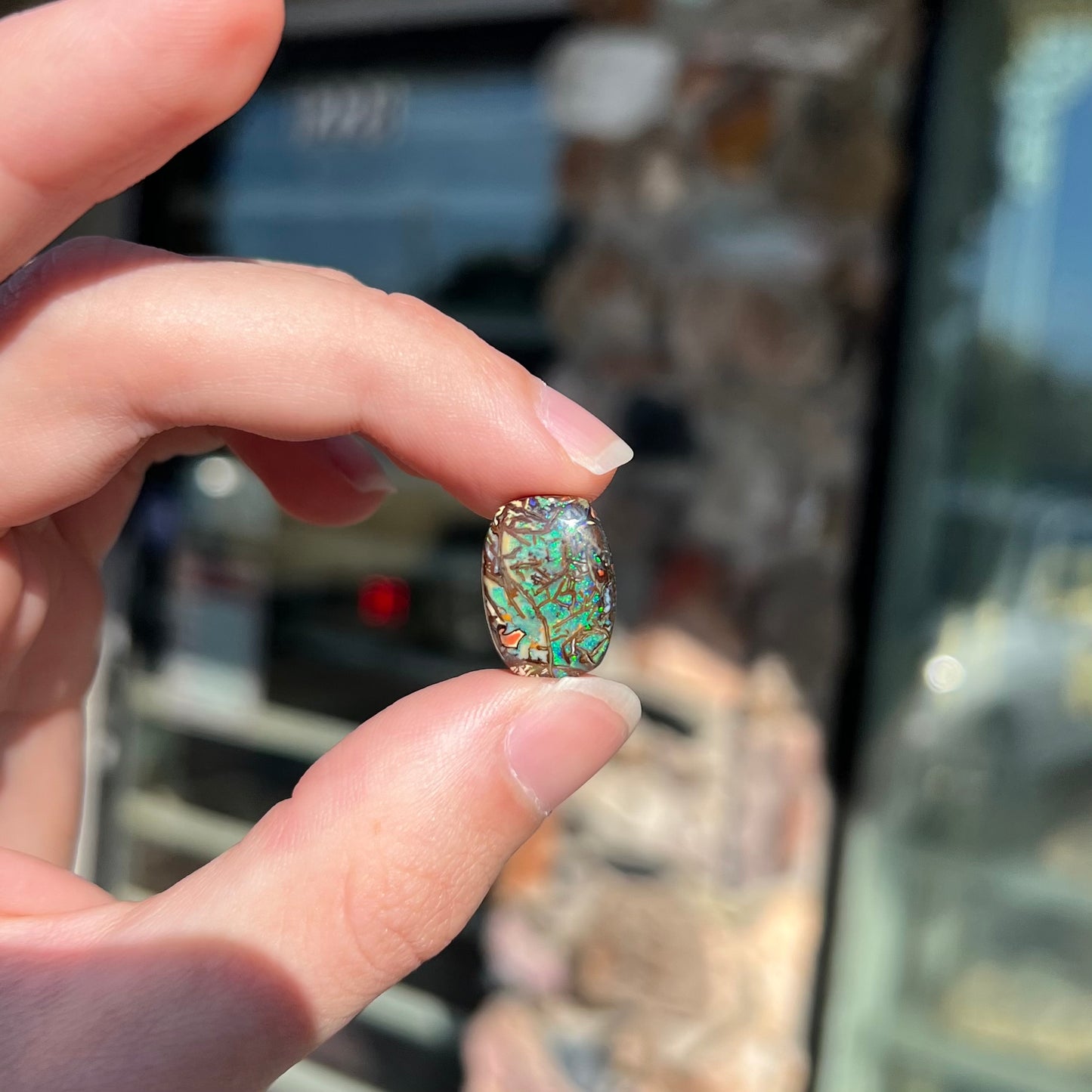 A barrel shaped boulder matrix opal from Koroit, Australia.  The opal has blue fire.