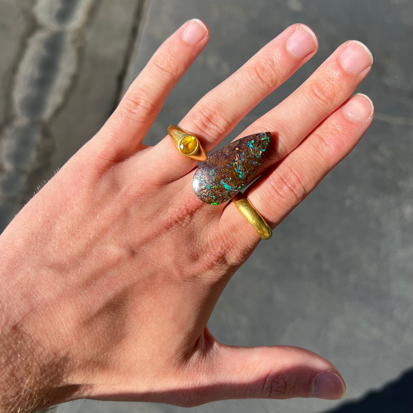 A pear shaped boulder opal stone from Koroit, Australia.  The opal has blue and green flashes.