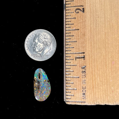 A loose boulder opal stone from Quilpie, Australia.  The opal shines colors of green and orange.