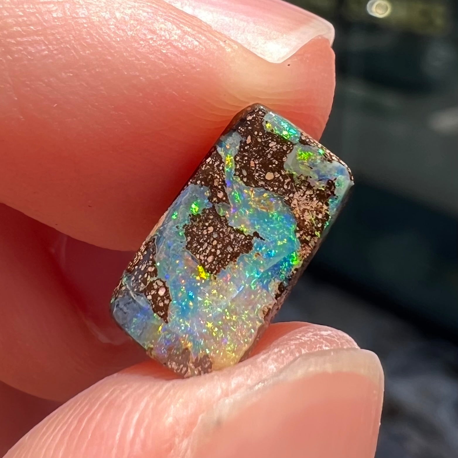 A loose, rectangular boulder opal stone from Quilpie, Australia.