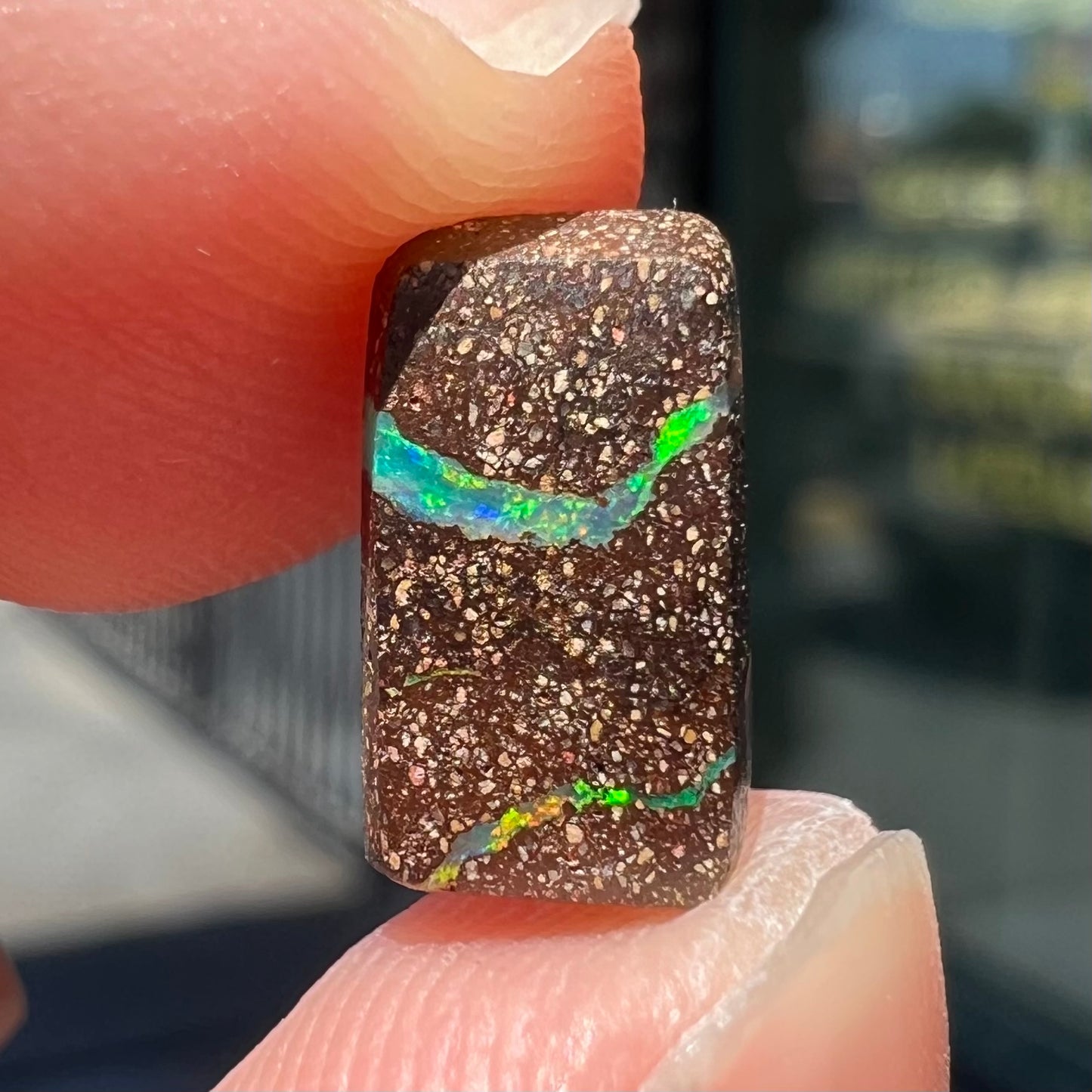 A loose, rectangular boulder opal stone from Quilpie, Australia.