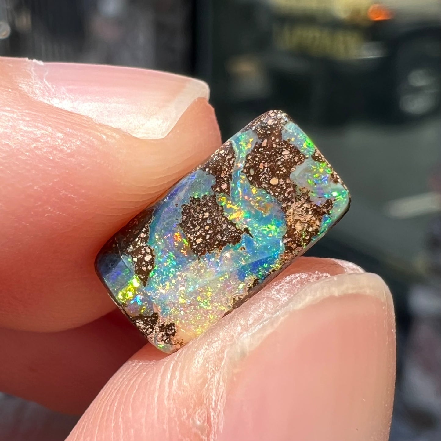 A loose, rectangular boulder opal stone from Quilpie, Australia.