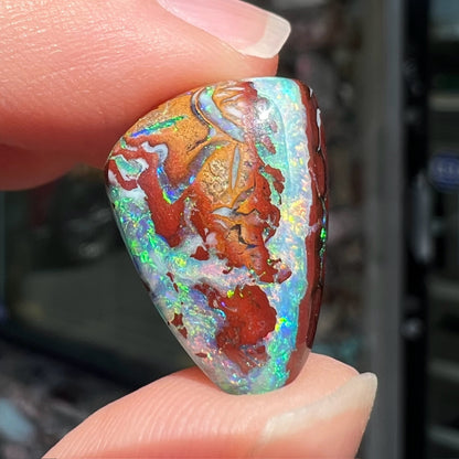 A polished matrix opal stone from Koroit, Australia.  The opal has a blue color.